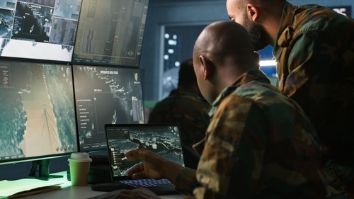 Army men looking at screen.